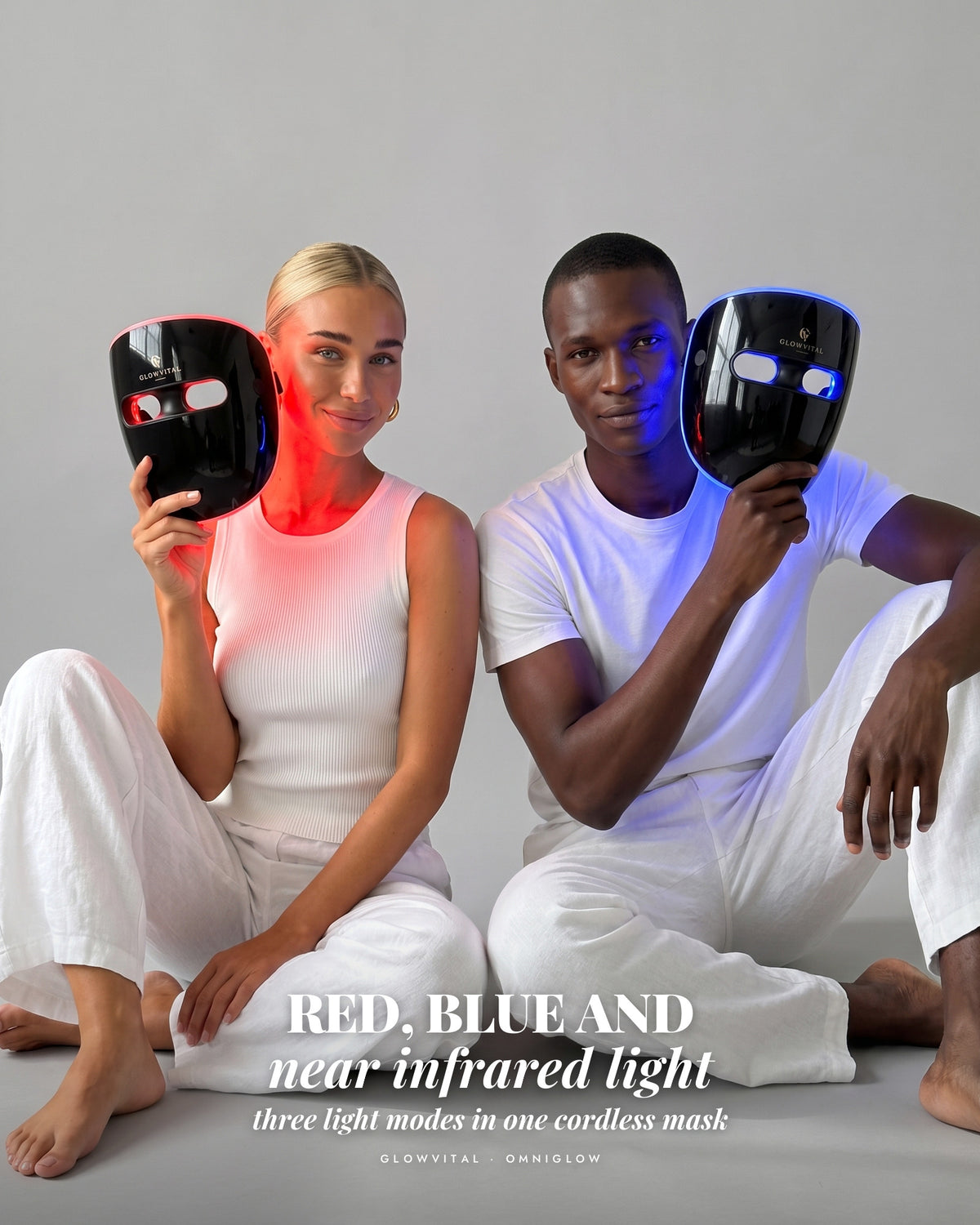 OmniGlow LED mask in red and blue light, held by two people