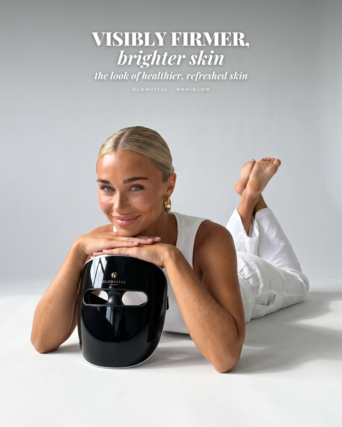 Woman lying on her front resting on the OmniGlow mask