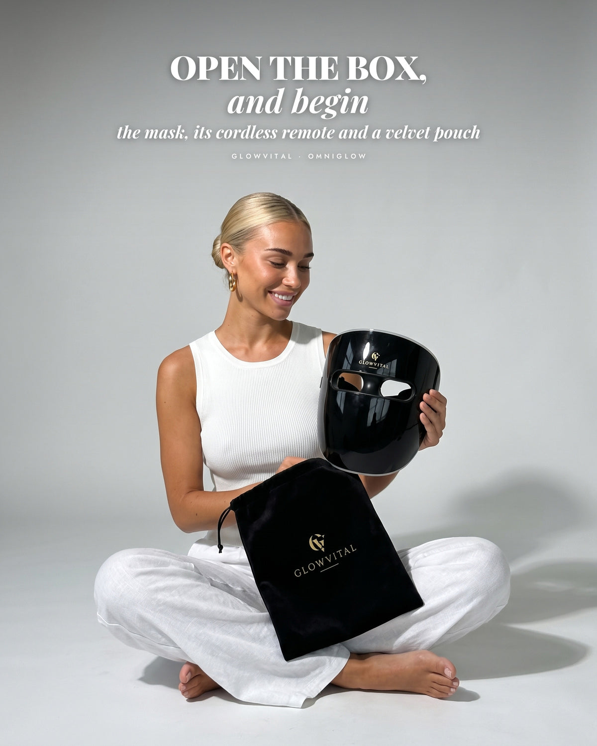Woman unboxing the OmniGlow mask and its velvet pouch